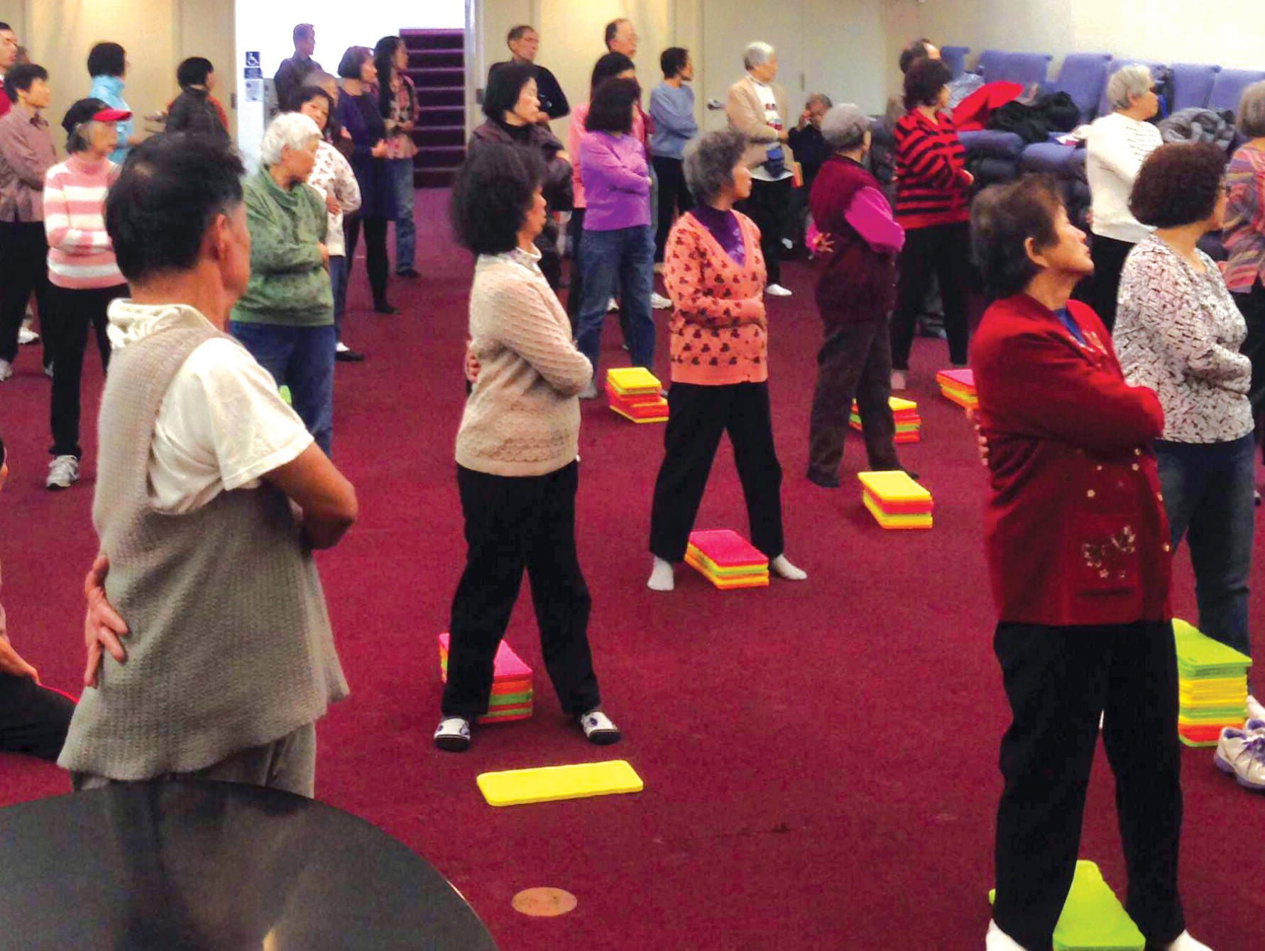 Group of adults exercising as part of a Chinatown clinic campaign