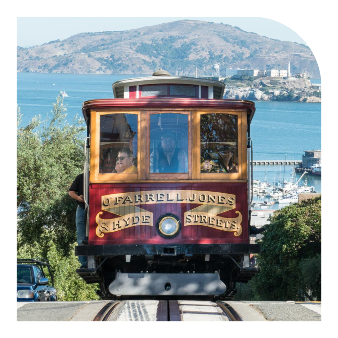 Photo of the front of a cable car with the bay in the background