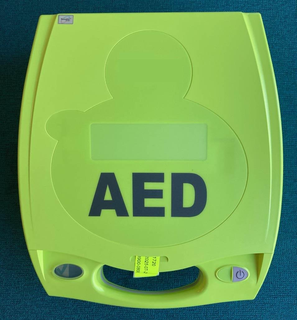 Yellow automated external defibrillator (AED) on blue background