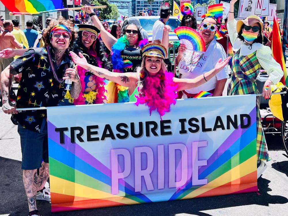 Treasure Island community members wearing festive garb participate in the SF Pride Parade