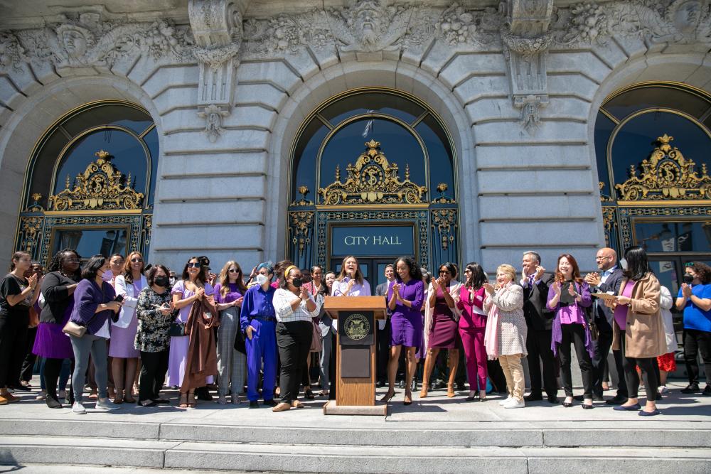 Citywide women leaders, dressed in purple, gathered in front of City Hall to celebrate Women's Equality Day.