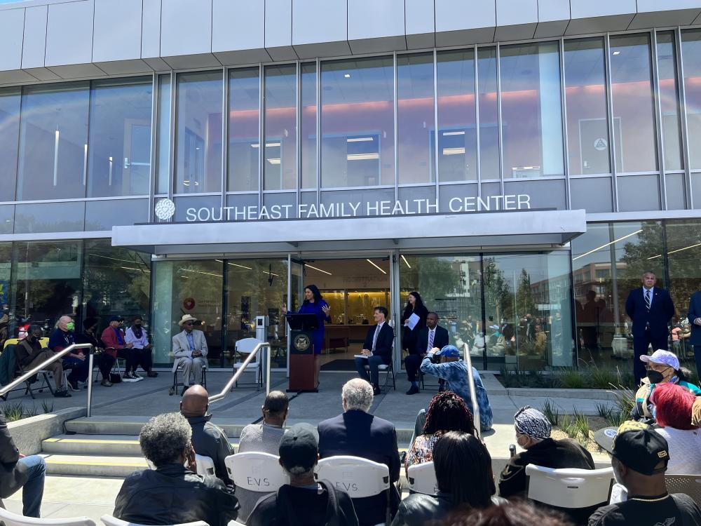 Ribbon cutting with mayor london breed in front of southeast family health center