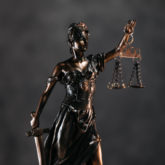 Statute of Lady Justice holding sword and scales