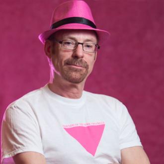 A man, wearing a pink hat, facing forward.
